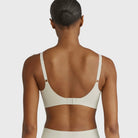 Beyond Bra in Aloe, light green sage wirefree bra on a model showing the back of the bra. 