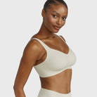 Beyond Bra in Aloe, light sage green wirefree bra on a model shown from a side view of the side band. 