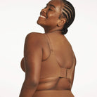 Beyond Bra in Clay, brown wirefree bra shown on a model from the back view showcasing the adjustable straps and hook and eye closure back. 