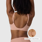 The Beyond Bra in Himalayan Salt, light pinkish neutral wirefree bra shown on a model from the back view so you can see the hook and eye back closure and adjustable straps. 