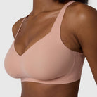 The Beyond Bra in Himalayan Salt, light pinkish neutral wirefree bra shown on a model with a close up view. 