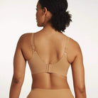 Beyond Bra in Mica, light tan wirefree bra shown on a model from the back view showing the adjustable straps and hook and eye back closure. 