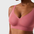 Woman wearing the Evelyn & Bobbie Evelyn Bra in Pink Canyon, dusty pink no wire pullover bra, on a white background, close up front view. 