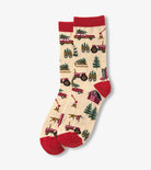Two socks with a festive design of tractors and Christmas trees on a beige background.