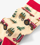 Sock with tractor and tree pattern on a beige background