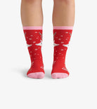 Red socks with pink accents worn by a person on a white background