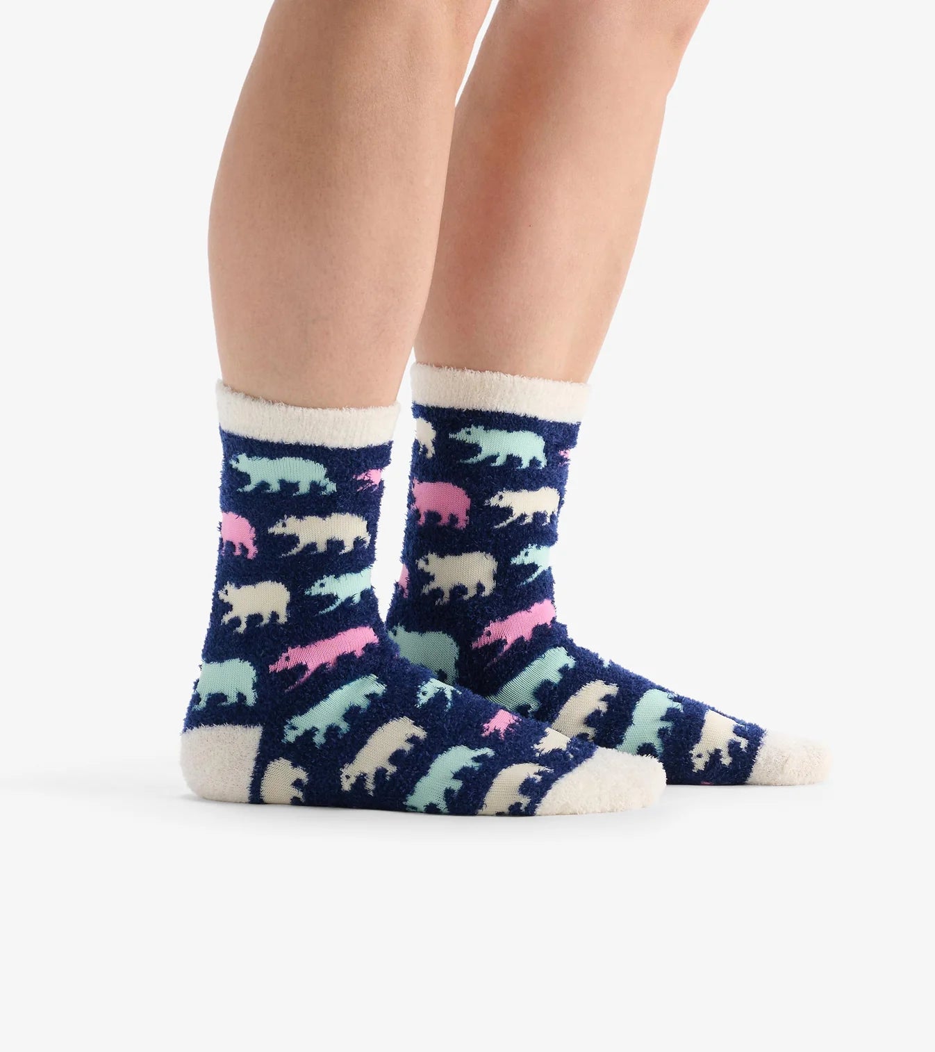 Colorful patterned socks with animal designs worn by a person on a white background