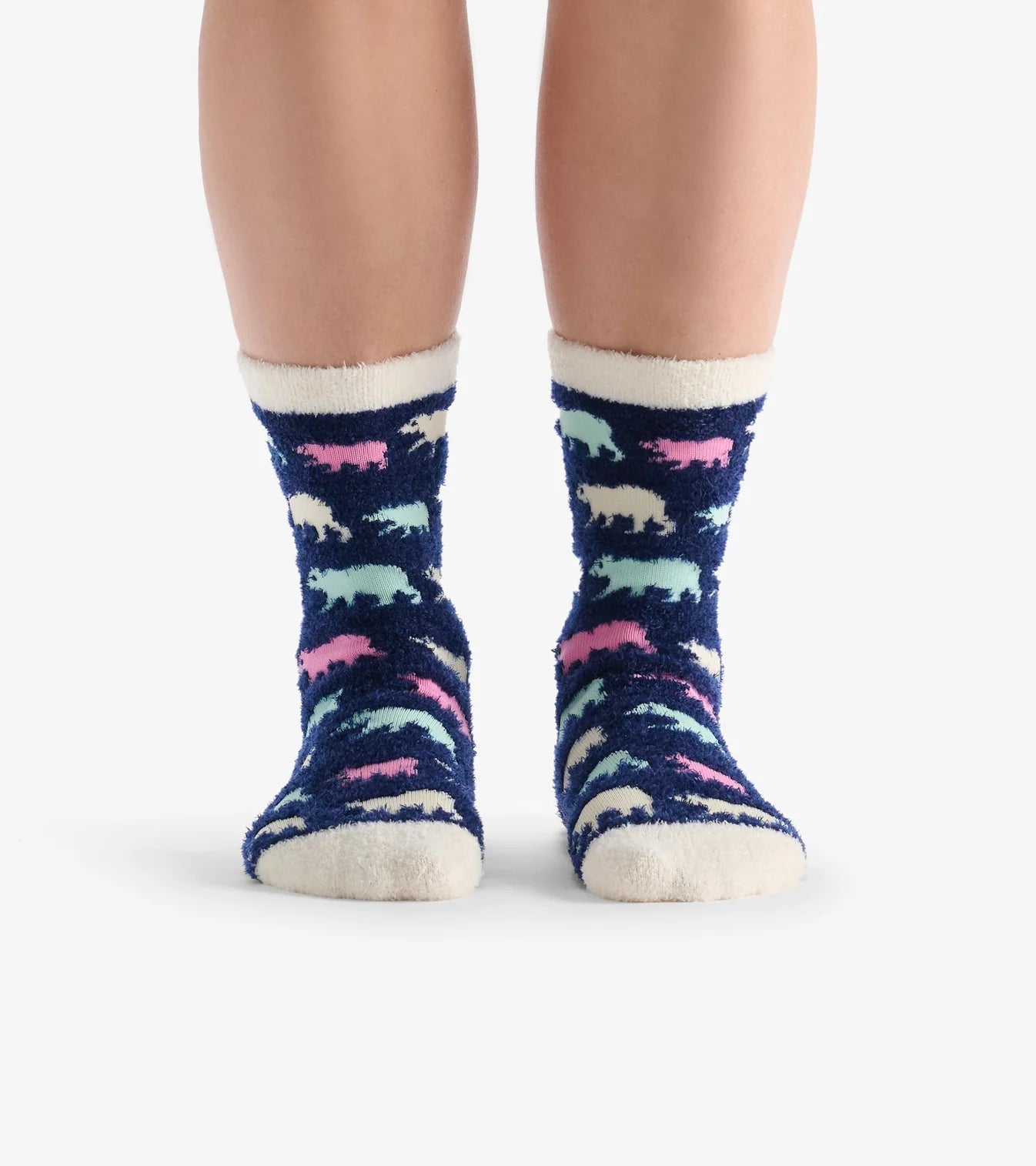 Navy socks with colorful animal patterns worn by a person on a white background
