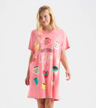 Woman wearing a pink nightshirt with coffee-themed graphics on a white background