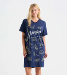 Woman wearing a navy blue nightshirt with celestial designs and 'Stargazer' text on a white background