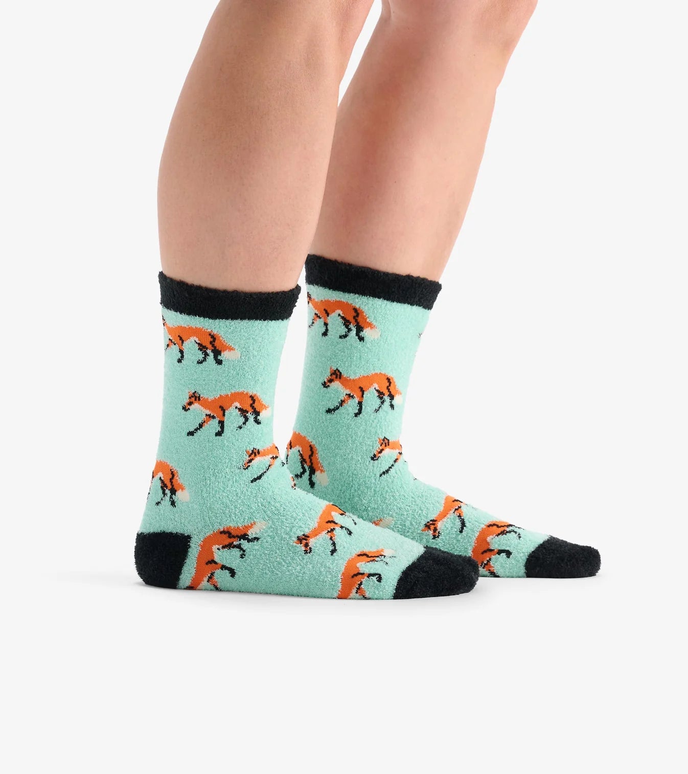 Teal socks with fox pattern worn by a person on a white background