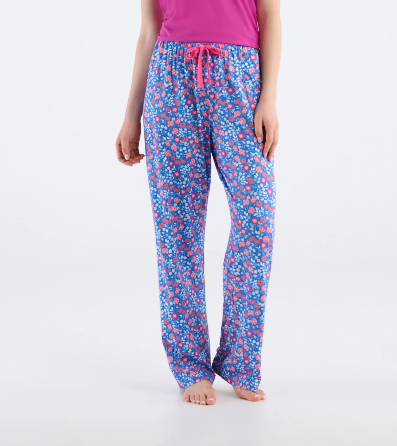 Floral patterned pajama pants worn by a person on a white background