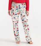 Person wearing patterned pajama pants with a red top on a white background