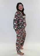 Woman wearing a floral patterned onesie on a white background