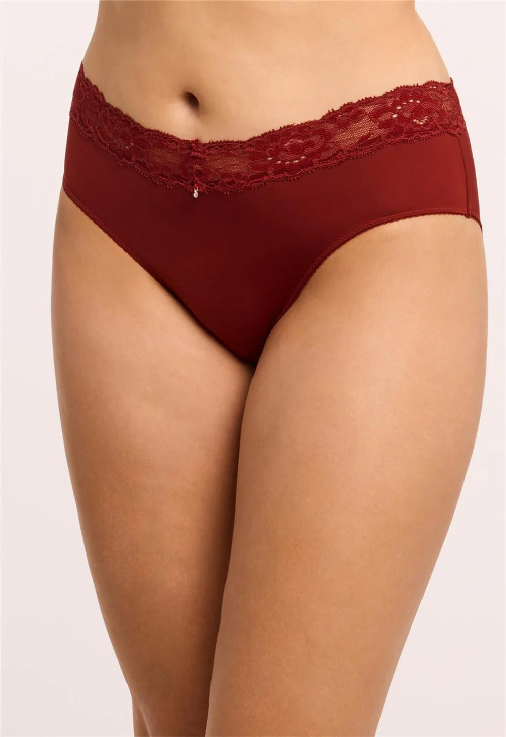Red lace-trimmed underwear on a plain background