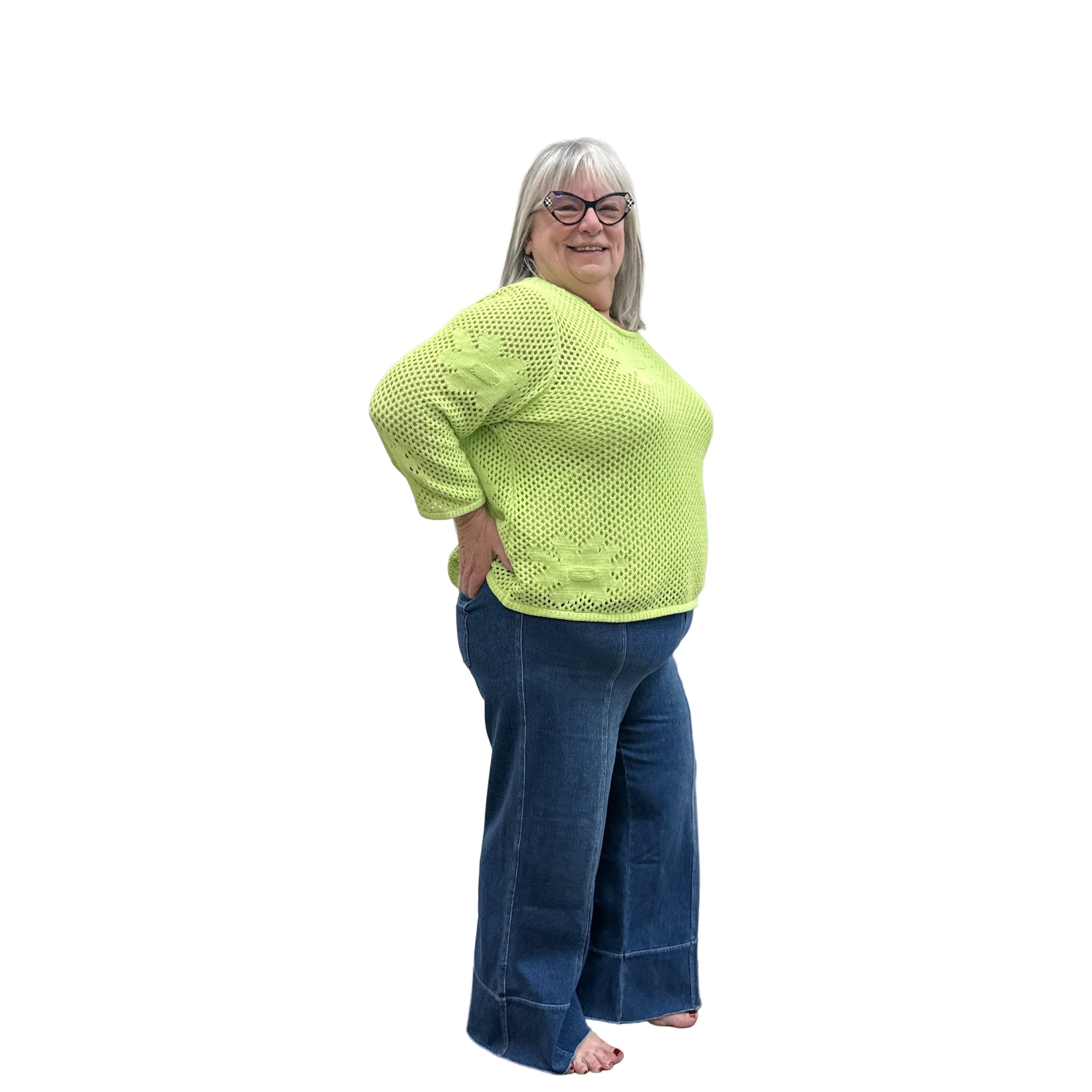 Person wearing a bright green Papa Easy Pullover sweater and blue jeans standing against a plain wall.