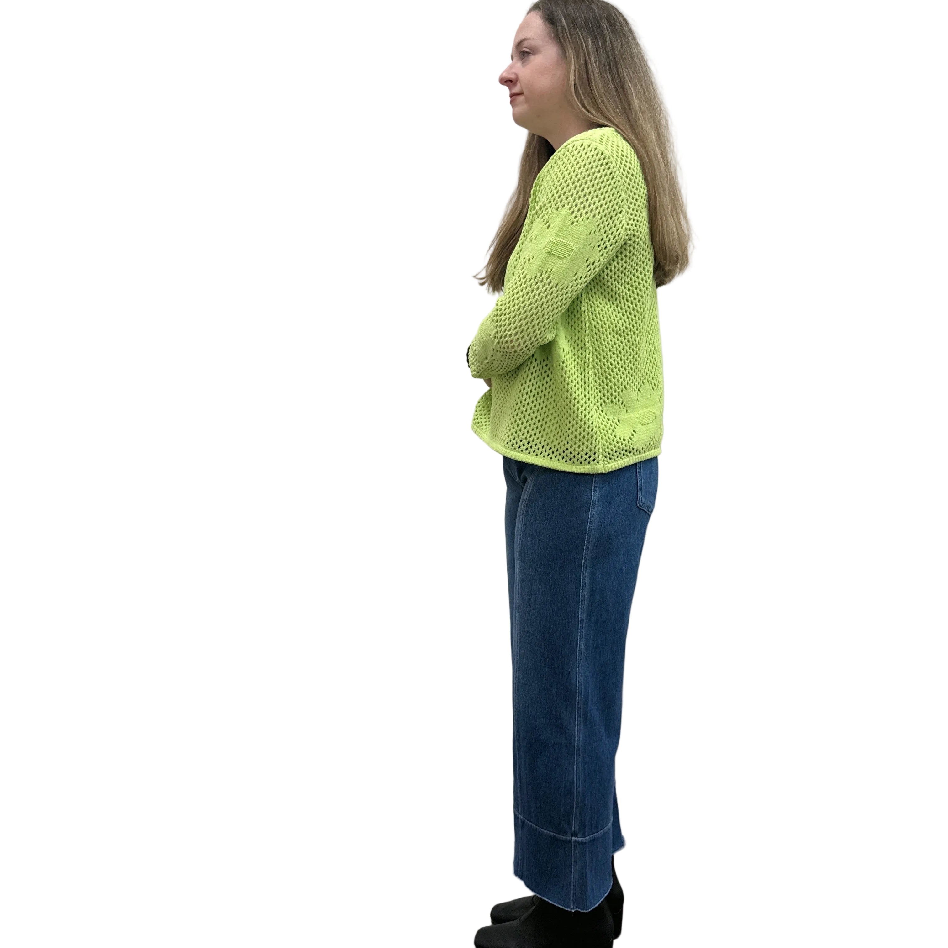 Person wearing a bright green Papa Easy Pullover sweater and blue jeans standing against a plain wall.