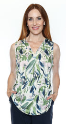 Woman wearing a sleeveless top with a floral pattern on a white background