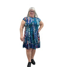 Woman wearing the Papa Indigo Mosaic Breeze patterned dress against a white background.