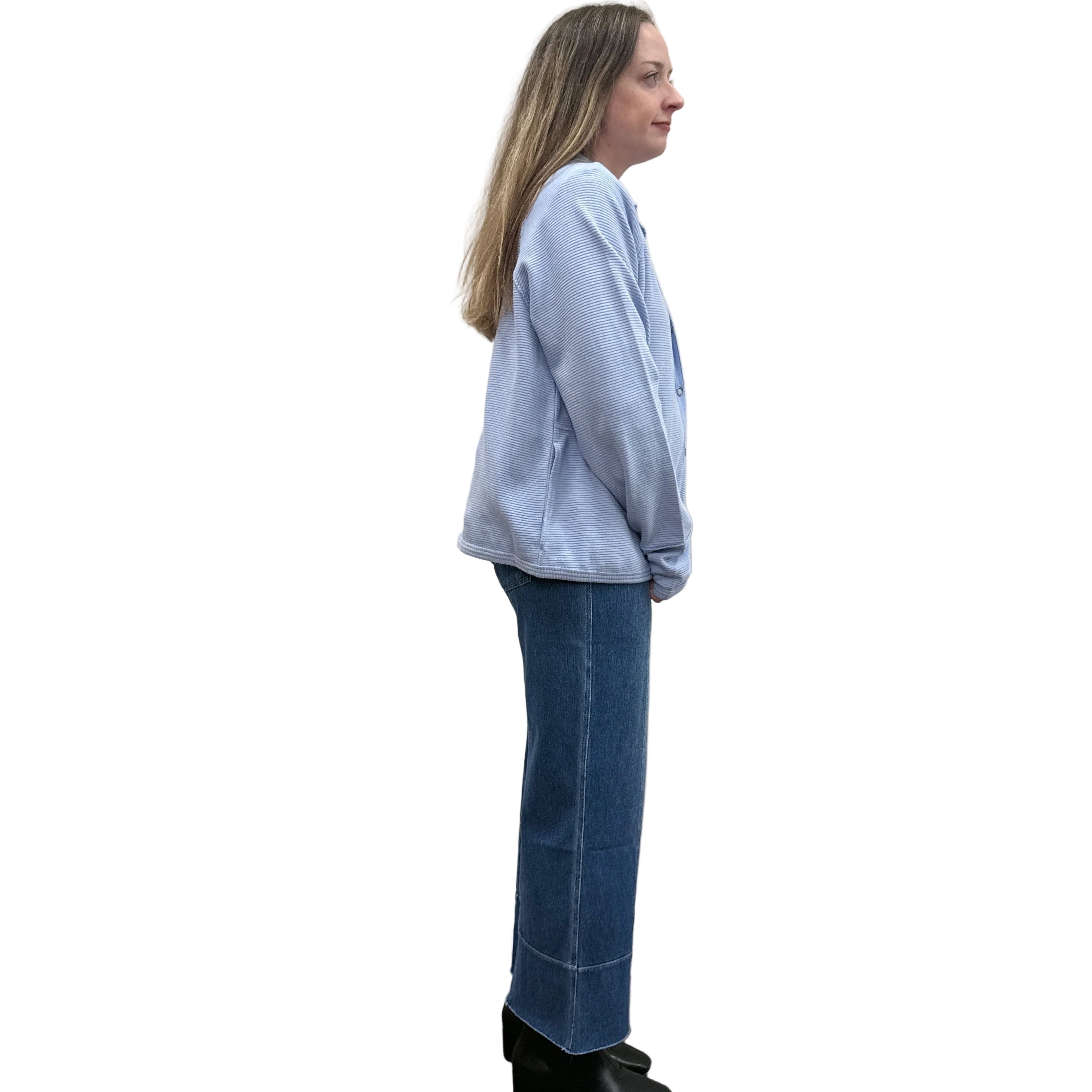 Person wearing a blue Papa Snappy Jacket sweater and jeans on a white background. 