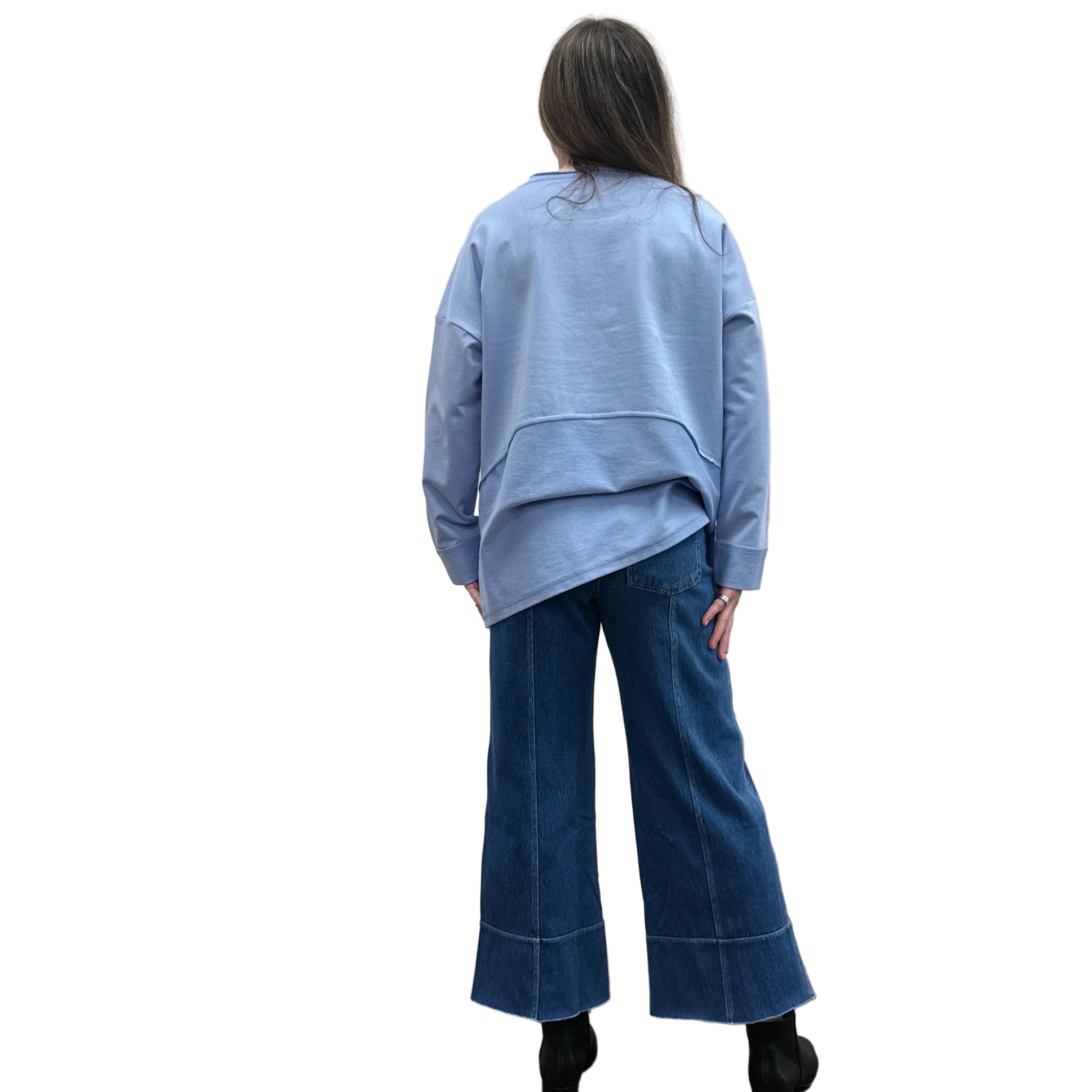 Person wearing a blue Papa Weekend Pullover sweater and jeans standing against a plain wall.