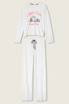 White long-sleeve pajama set with 'Cabin Cozy' graphic on a beige background