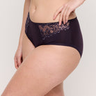 Navy blue lace-trimmed underwear on a plain background