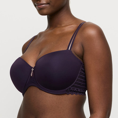 Purple bra worn by a model on a plain background
