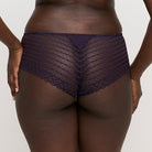 Fishnet underwear worn by a person on a plain background