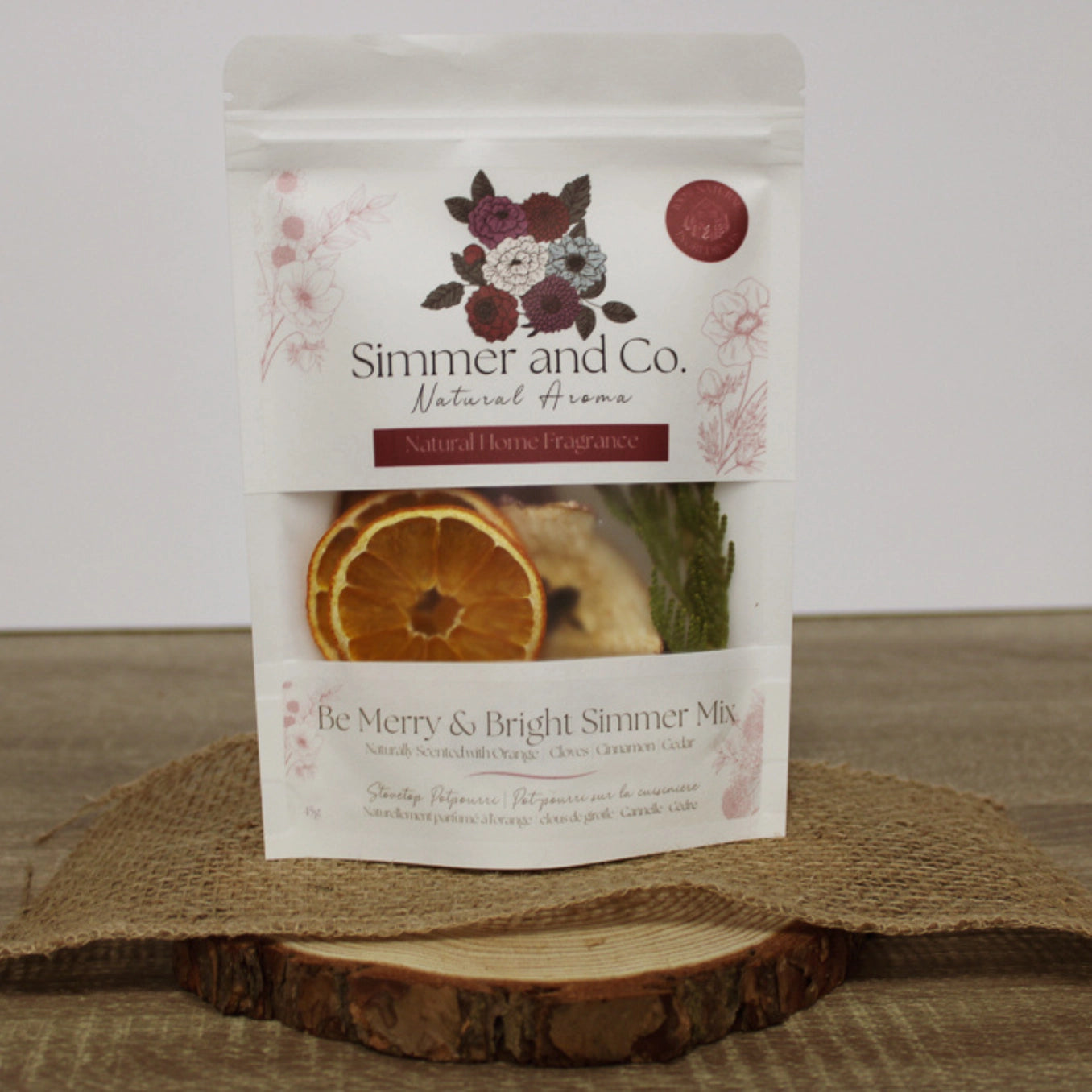 Simmer and Co. natural home fragrance package on a wooden surface with a white background