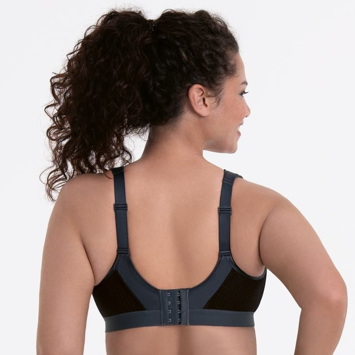 Extreme Control Sports Bra in Black shown on a model, from the back showing the straps and band. 