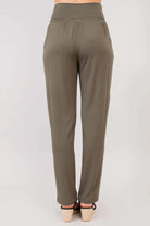 Blue Sky Clair bamboo pants in khaki shown on a model against a white background, from the back view. 