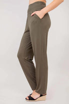 Blue Sky Clair bamboo pants in khaki shown on a model against a white background, from the side view. 