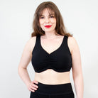Blue Sky Clipper Top in Black shown on a model against a white background, worn with black bottoms. 