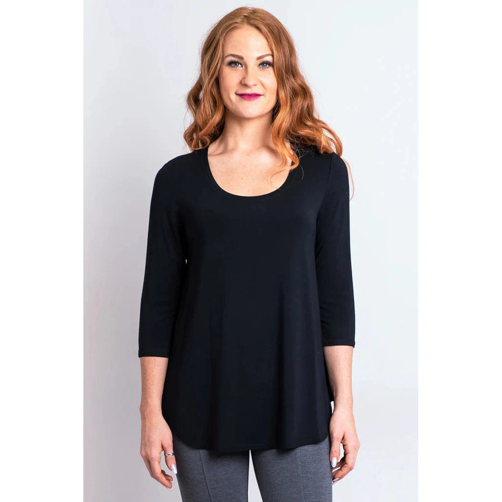 Blue Sky Jazz 3/4 Sleeve Top in Black shown on a model wearing grey leggings standing against a white background, from the front view. 