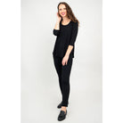 Blue Sky Jazz 3/4 Sleeve Top in Black shown on a model wearing black leggings standing against a white background, from the front view. 