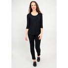 Blue Sky Jazz 3/4 Sleeve Top in Black shown on a model wearing black leggings standing against a white background, from the front view. 