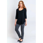 Blue Sky Jazz 3/4 Sleeve Top in Black shown on a model wearing grey leggings standing against a white background, from the front view. 