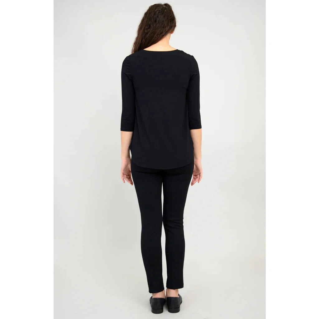 Blue Sky Jazz 3/4 Sleeve Top in Black shown on a model wearing black leggings standing against a white background, from the back view. 