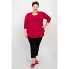 Blue Sky Jazz 3/4 Sleeve Top in Lipstick Red shown on a model wearing black leggings against a white background, from the front view. 