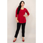 Blue Sky Jazz 3/4 Sleeve Top in Lipstick Red shown on a model wearing black leggings against a white background, from the front view. 