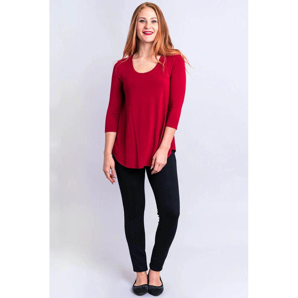 Blue Sky Jazz 3/4 Sleeve Top in Lipstick Red shown on a model wearing black leggings against a white background, from the front view. 