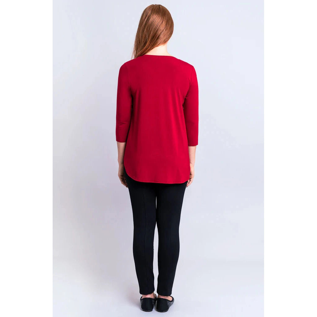 Blue Sky Jazz 3/4 Sleeve Top in Lipstick Red shown on a model wearing black leggings against a white background, from the back view. 