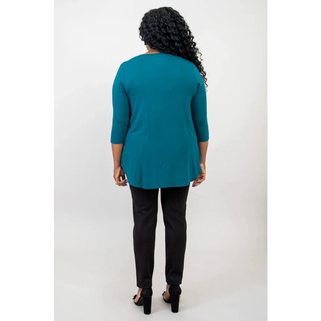 Blue Sky Jazz 3/4 Sleeve Top in Teal shown on a model wearing black leggings against a white background, from the back view. 