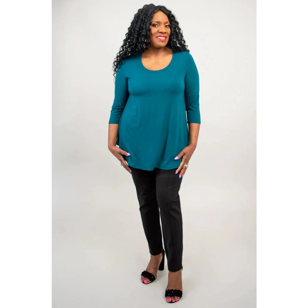 Blue Sky Jazz 3/4 Sleeve Top in Teal shown on a model wearing black leggings against a white background, from the front view. 