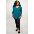 Blue Sky Jazz 3/4 Sleeve Top in Teal shown on a model wearing black leggings against a white background, from the front view. 