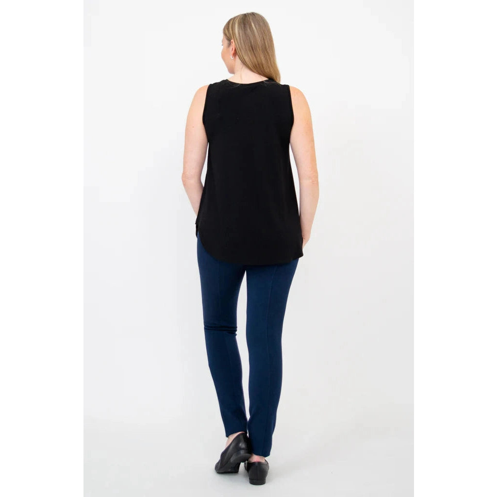 Blue Sky Jazz Tank in Black shown on a model wearing blue leggings standing against a white background, from the back view. 