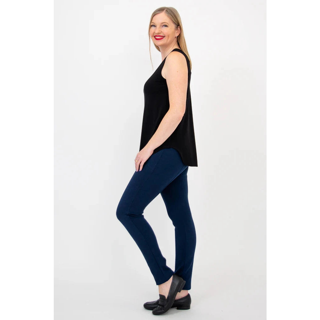 Blue Sky Jazz Tank in Black shown on a model wearing blue leggings standing against a white background, from the side view. 