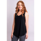 Blue Sky Jazz Tank in Black shown on a model wearing grey leggings standing against a white background, from the front view. 