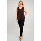 Blue Sky Jazz Tank in Coffee shown on a model wearing black leggings, against a white background, from the front view. 